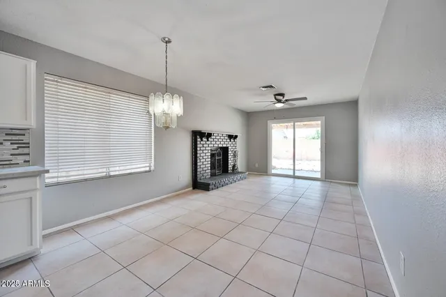 a view of a room with window and chandelier fan