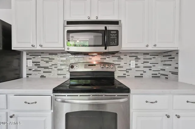 a stove top oven sitting inside of a kitchen