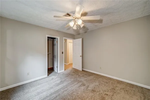 an empty room with fan and a ceiling fan
