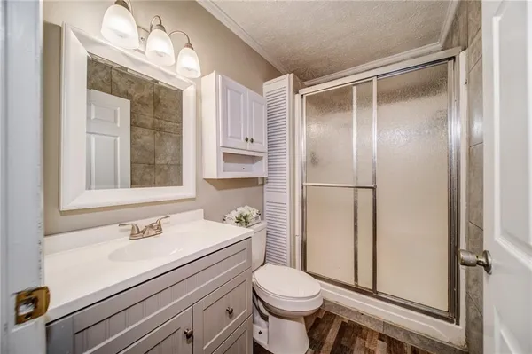 a bathroom with a sink toilet and shower