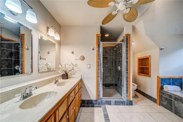 a bathroom with a sink a mirror and a shower
