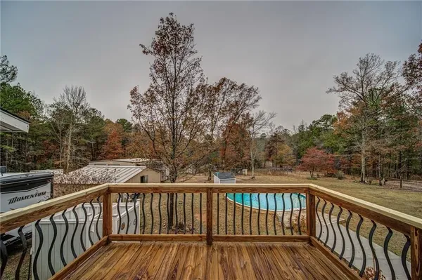 a view of balcony with wooden fence and floor
