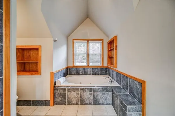 a bathroom with a tub and windows