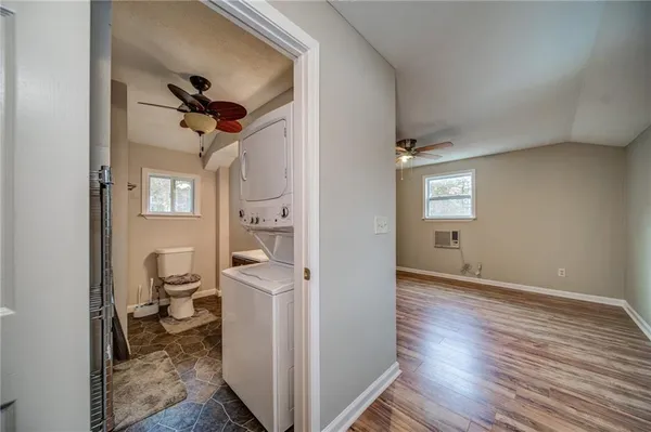 a view of a way to kitchen and dining room with wooden floor
