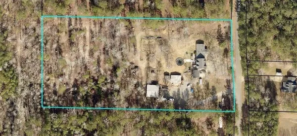 a view of house with a small yard