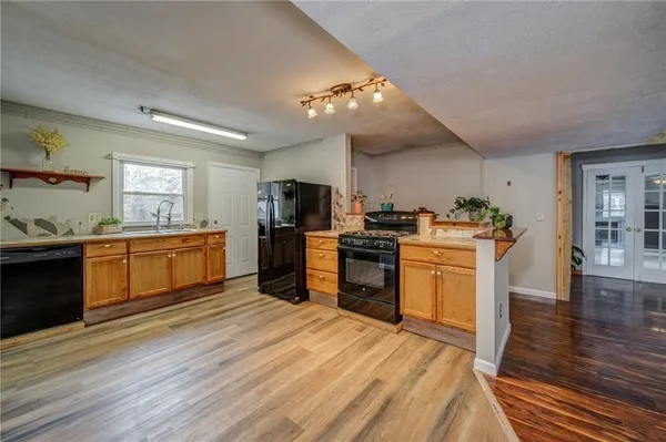 a kitchen with granite countertop a stove top oven and cabinets