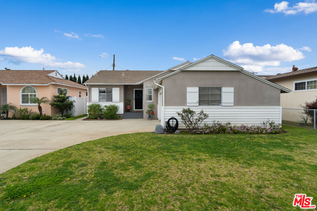 1162 West 149th Street Gardena, CA 90247 - Photo 1 of 26 a front view of a house with a garden