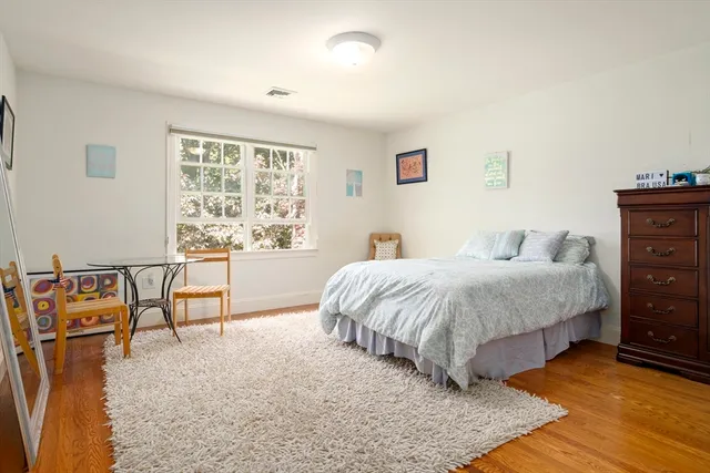 a spacious bedroom with a bed and a window