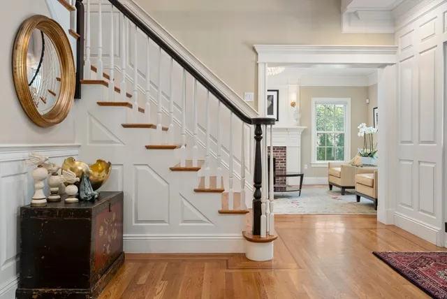 a view of entryway and hall with wooden floor