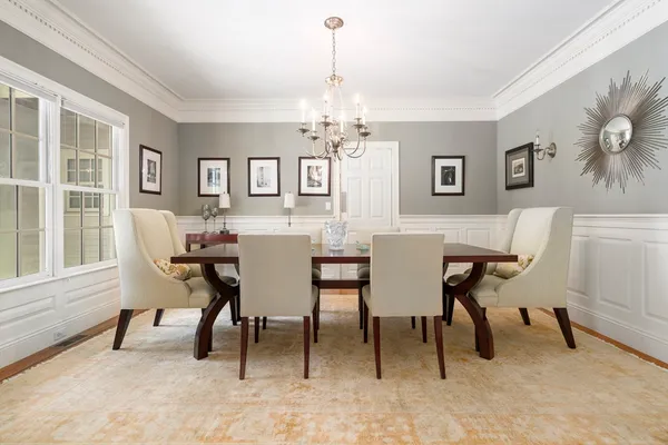 a view of a dining room with furniture and a chandelier