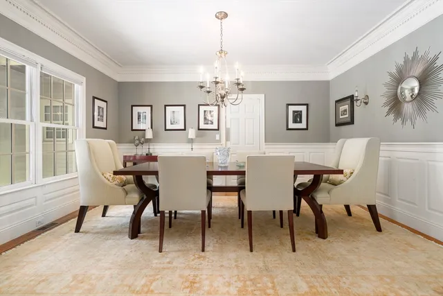 a view of a dining room with furniture and a chandelier
