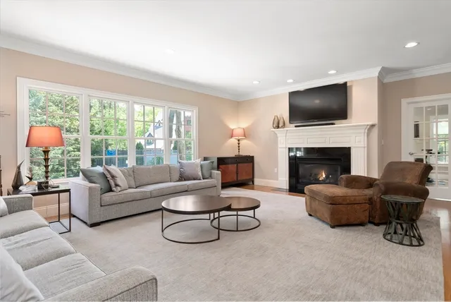 a living room with furniture flat screen tv and a fireplace