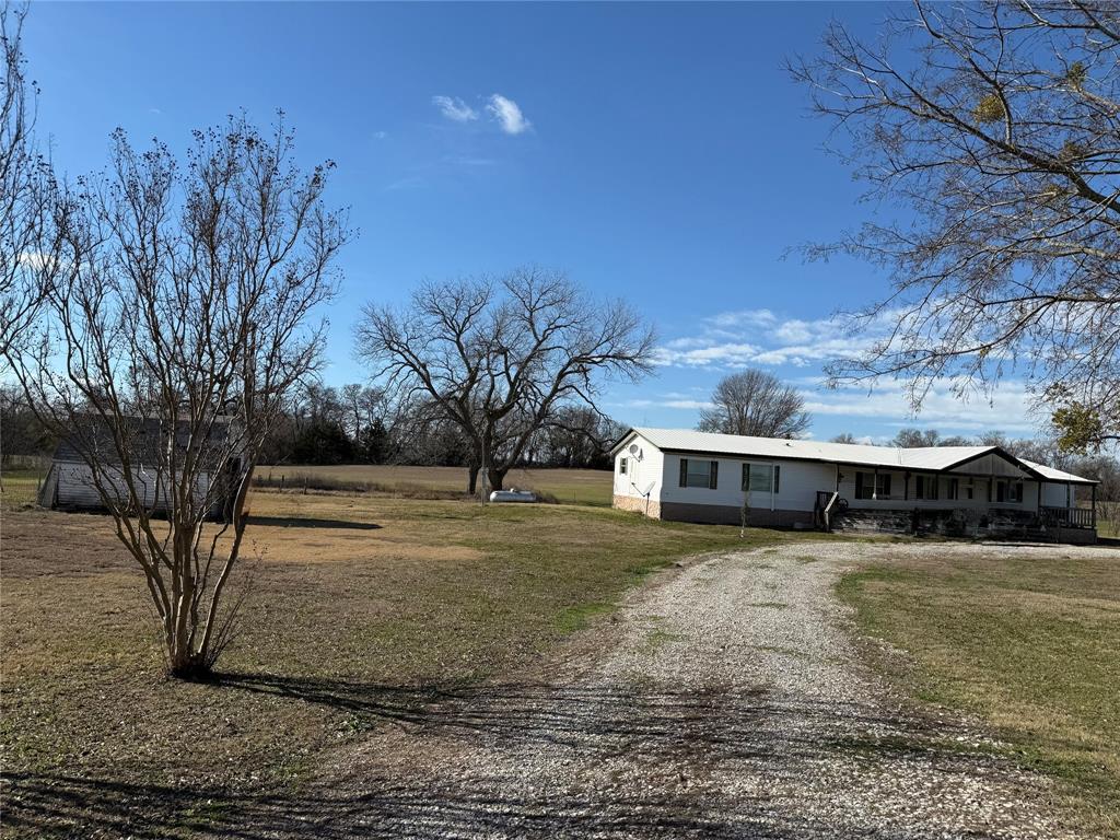 7187 County Road 1037 Blue Ridge, TX 75424 - Photo 2 of 9 a view of a house with a yard