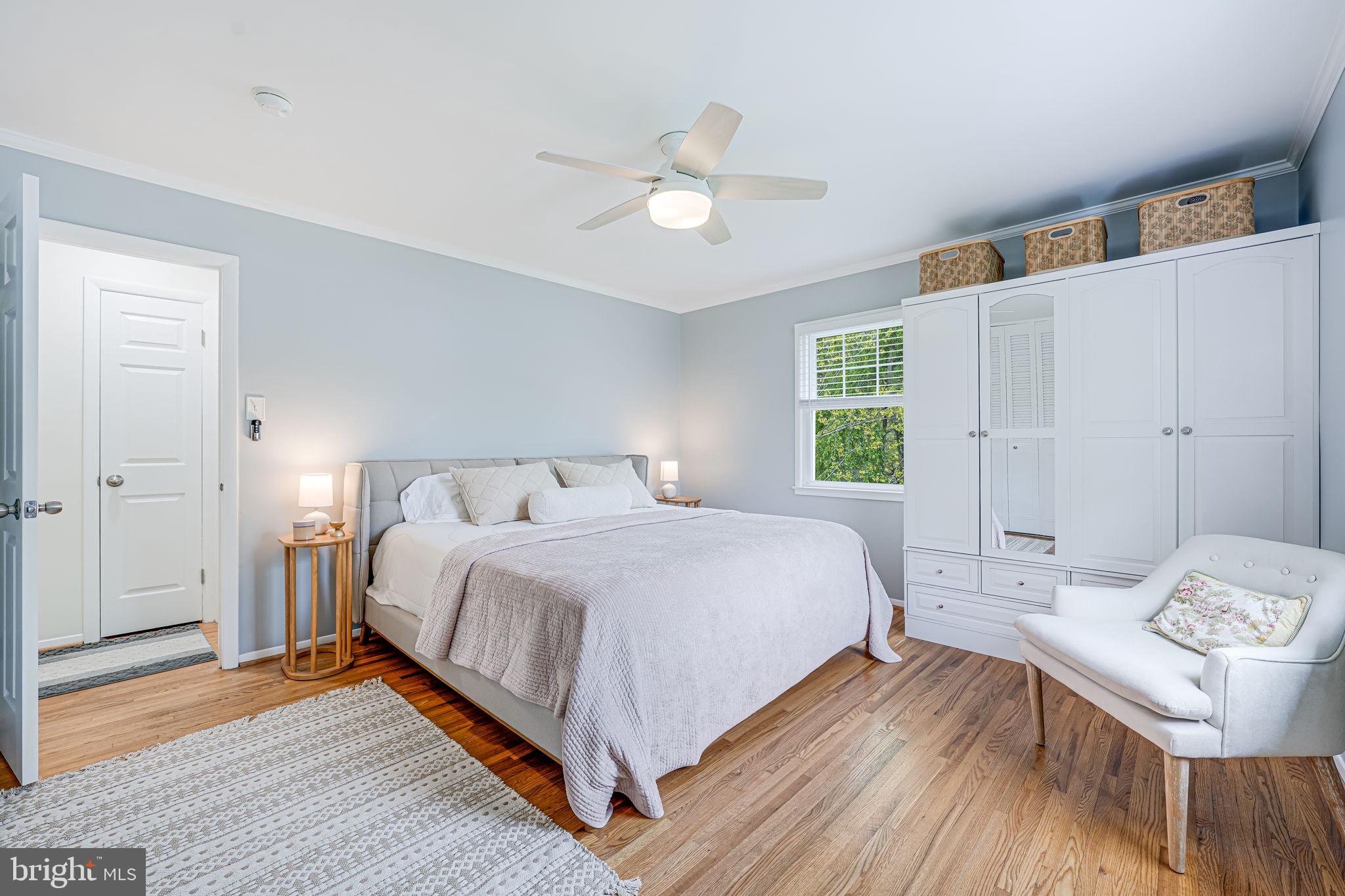 8315 Greeley Boulevard Springfield, VA 22152 - Photo 14 of 44 a bed room with a bed and a chandelier