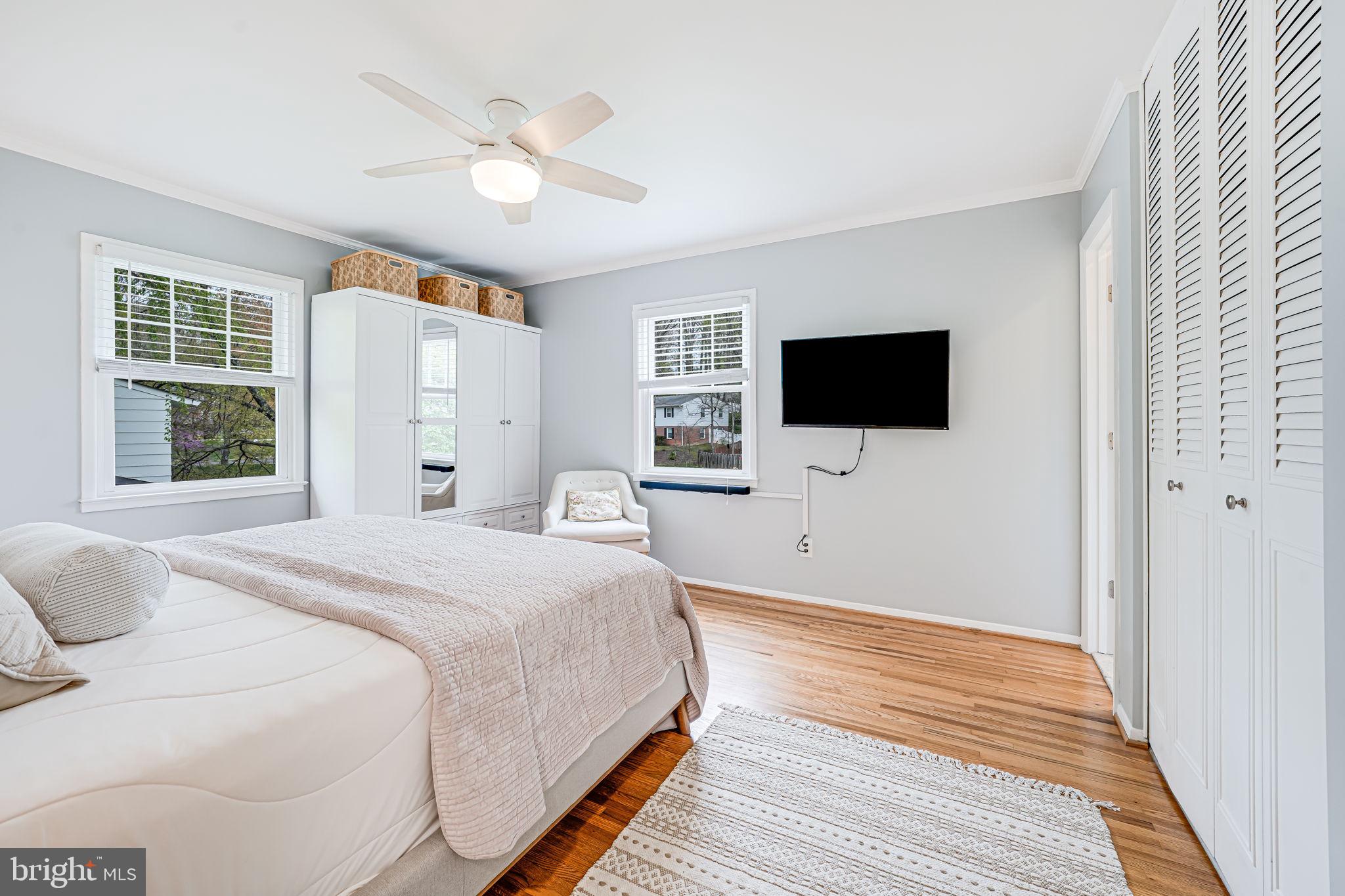 8315 Greeley Boulevard Springfield, VA 22152 - Photo 15 of 44 a bedroom with a large bed and a flat screen tv
