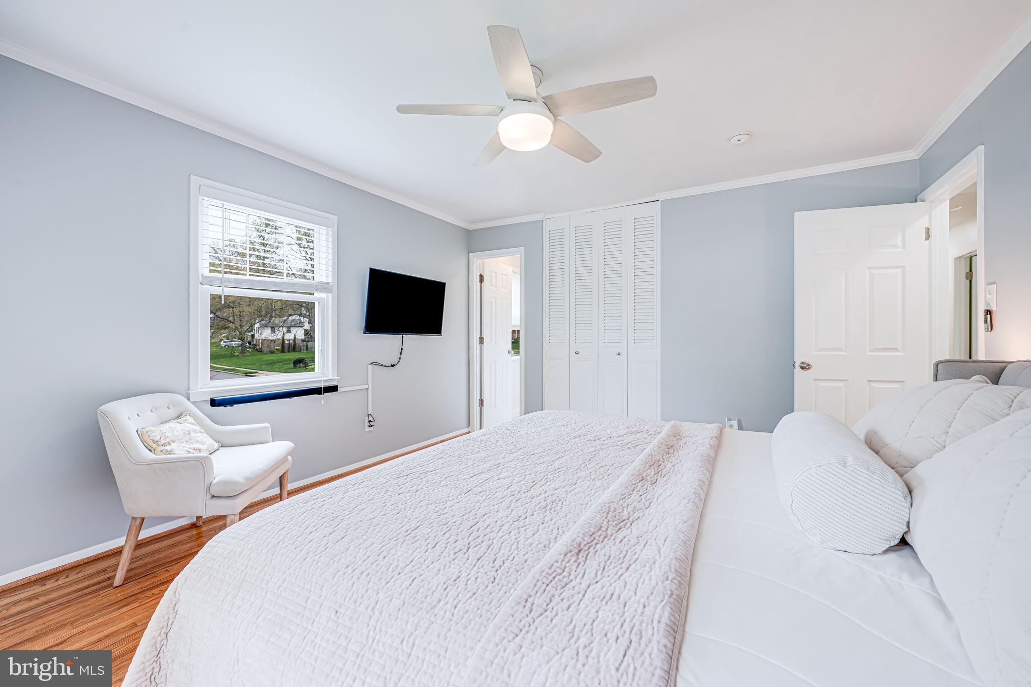 8315 Greeley Boulevard Springfield, VA 22152 - Photo 16 of 44 a bedroom with a bed tv and a window