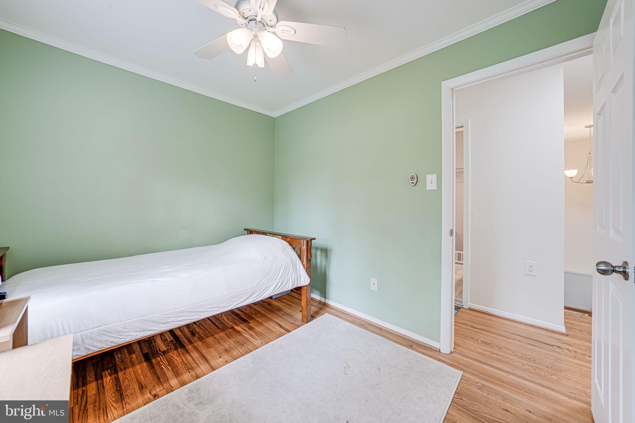 8315 Greeley Boulevard Springfield, VA 22152 - Photo 21 of 44 a bedroom with a bed and wooden floor