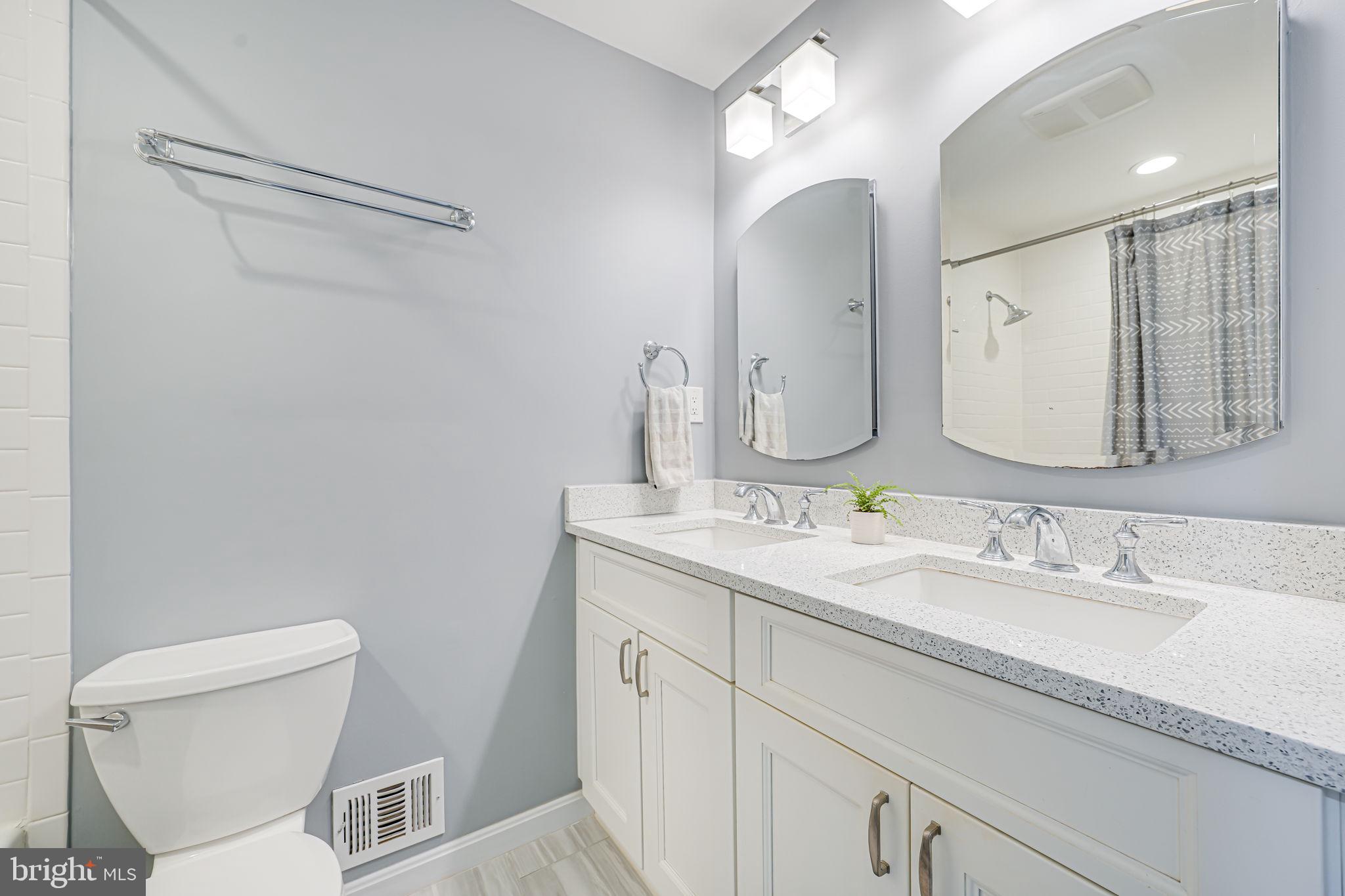 8315 Greeley Boulevard Springfield, VA 22152 - Photo 24 of 44 a bathroom with a toilet sink and mirror