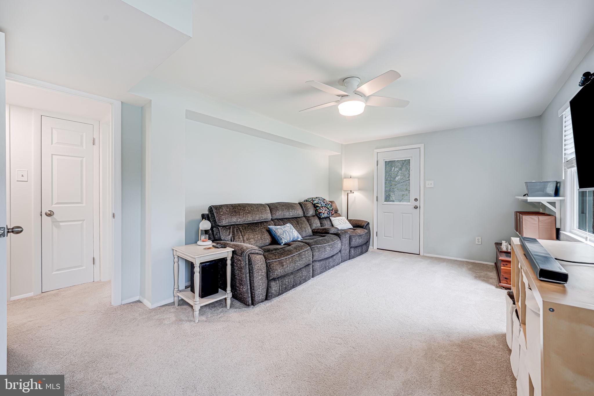 8315 Greeley Boulevard Springfield, VA 22152 - Photo 25 of 44 a living room with furniture a ceiling fan and a window