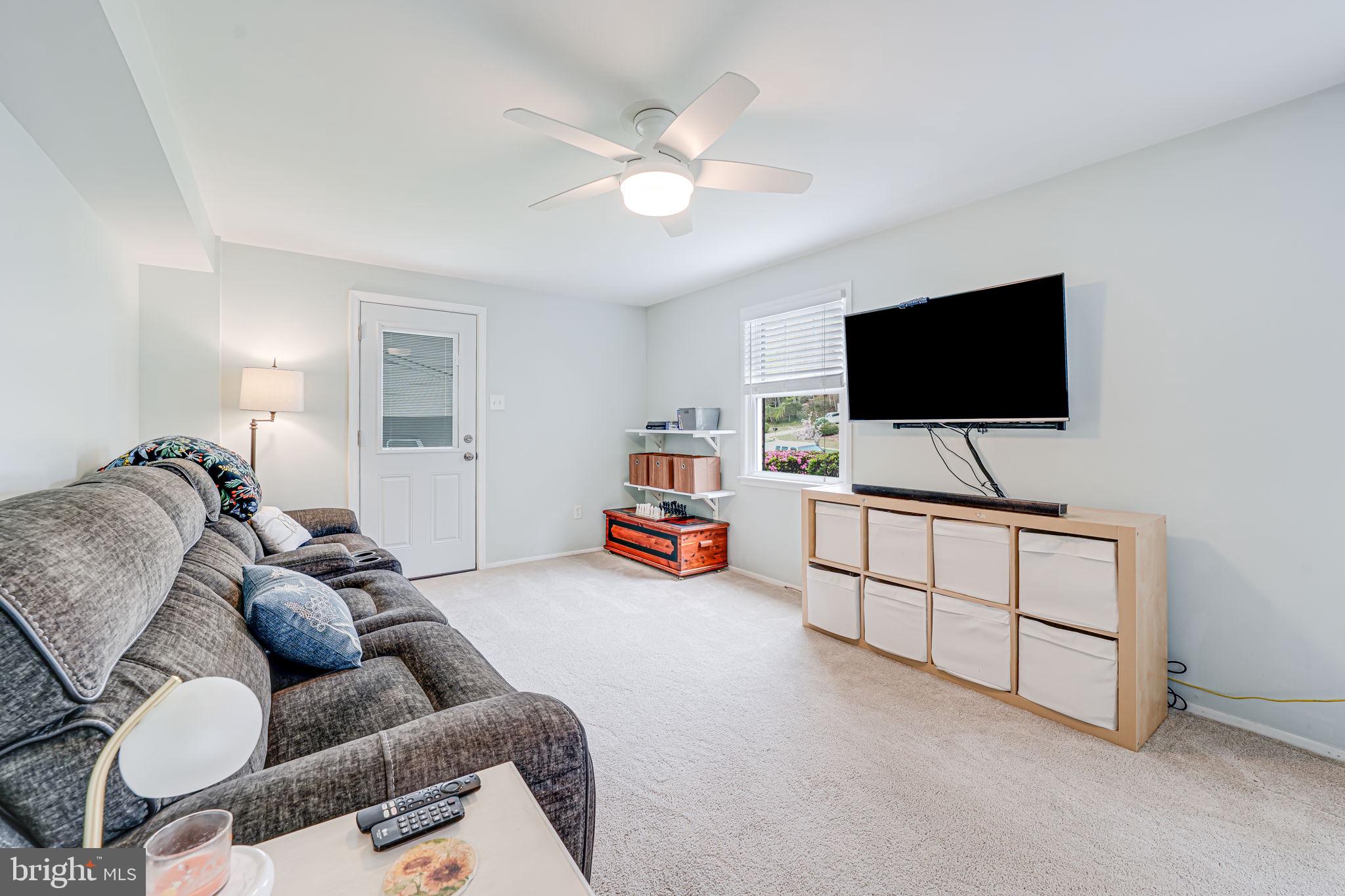 8315 Greeley Boulevard Springfield, VA 22152 - Photo 26 of 44 a living room with furniture and a flat screen tv