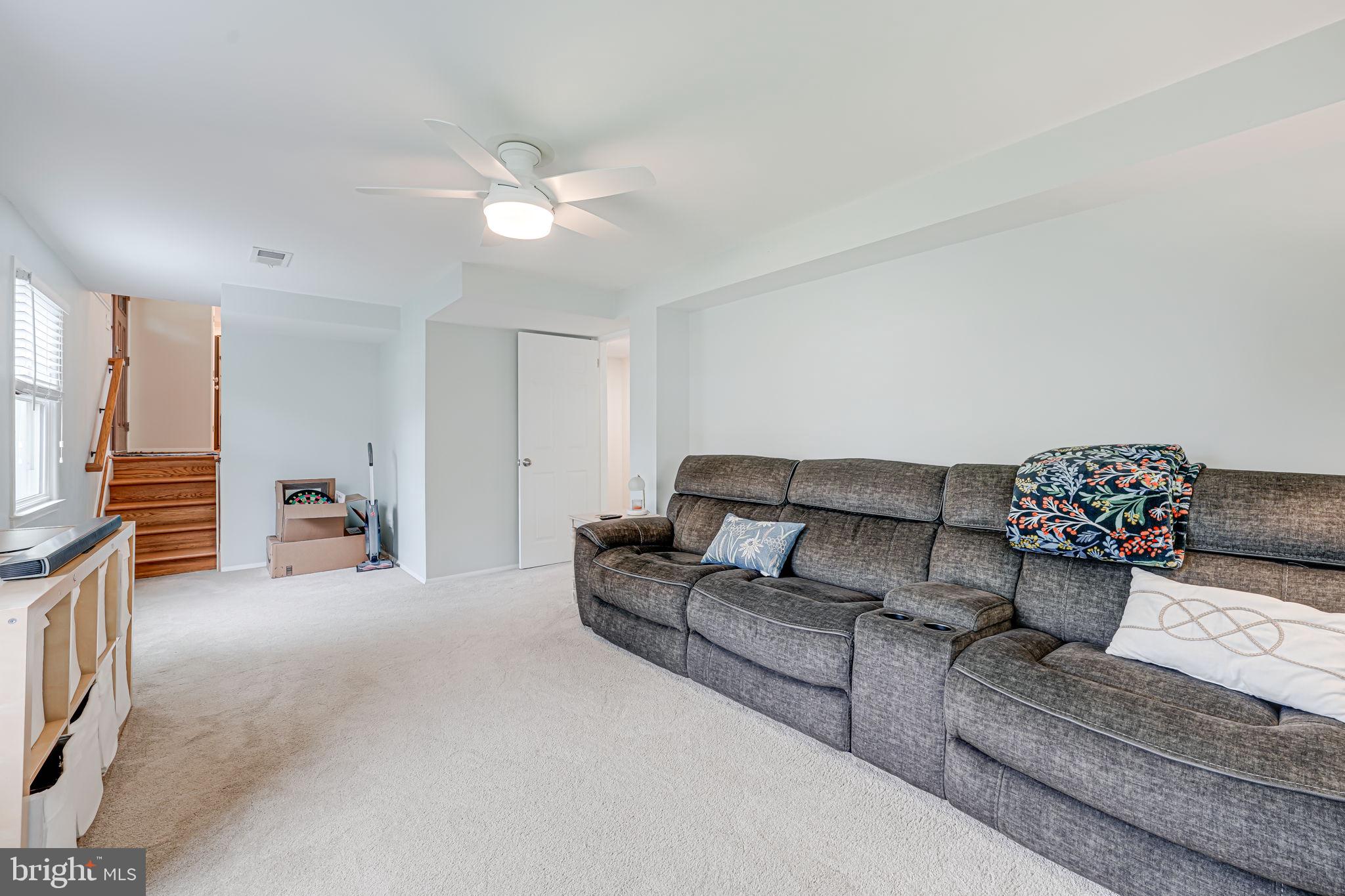 8315 Greeley Boulevard Springfield, VA 22152 - Photo 27 of 44 a living room with furniture and a chandelier