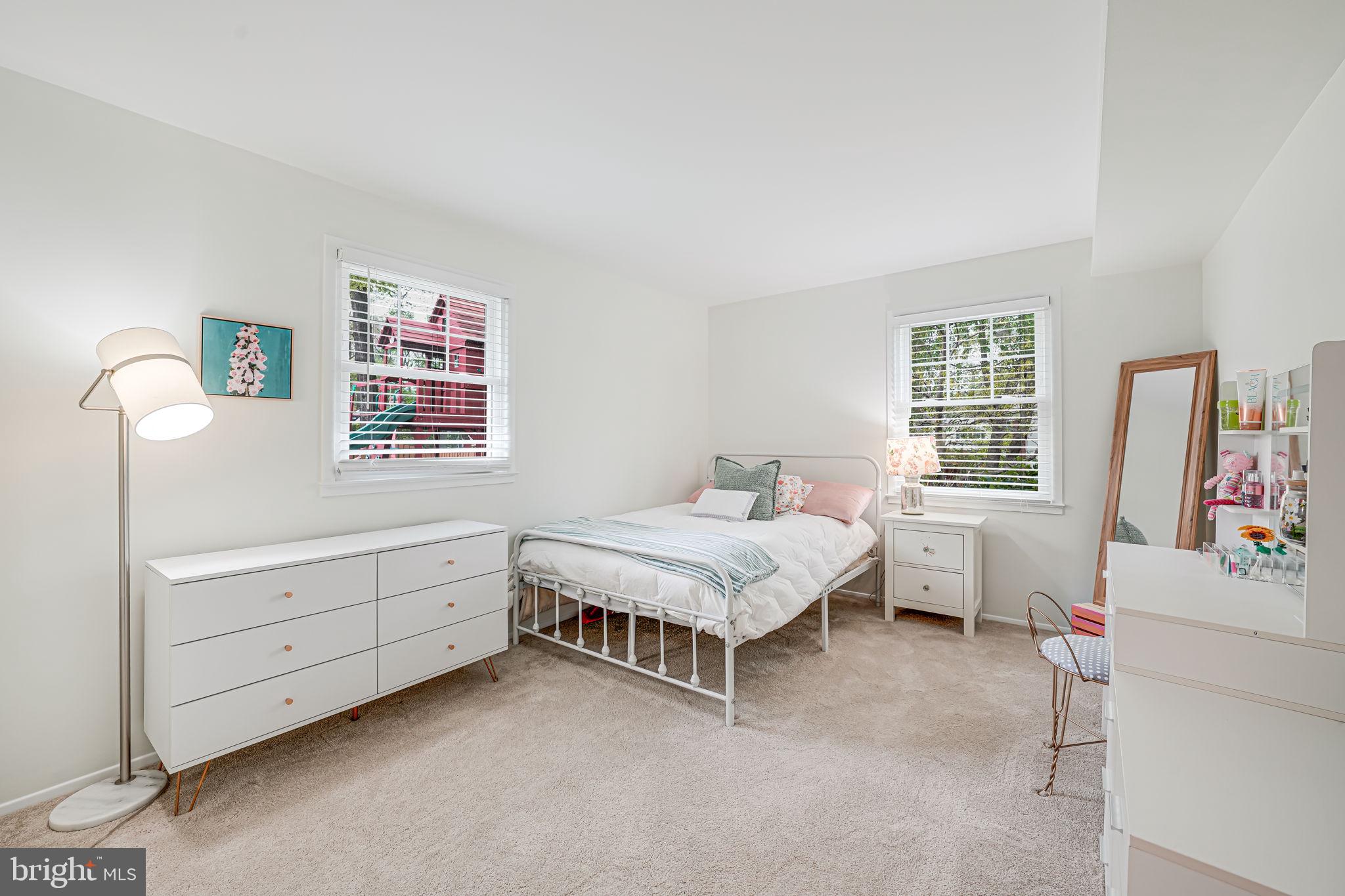 8315 Greeley Boulevard Springfield, VA 22152 - Photo 28 of 44 a spacious bedroom with a bed and a window