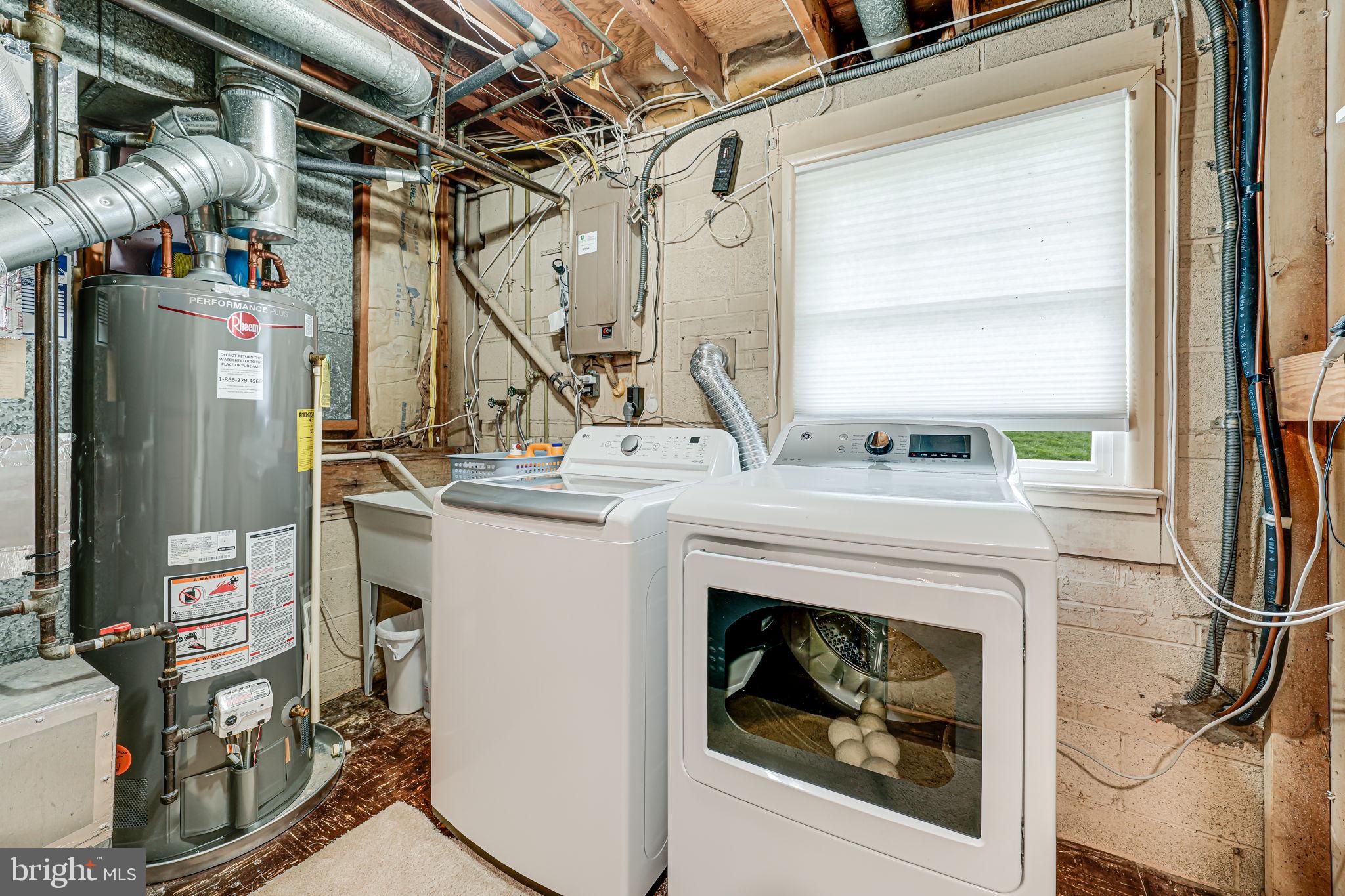 8315 Greeley Boulevard Springfield, VA 22152 - Photo 31 of 44 a utility room with a fireplace dryer and washer