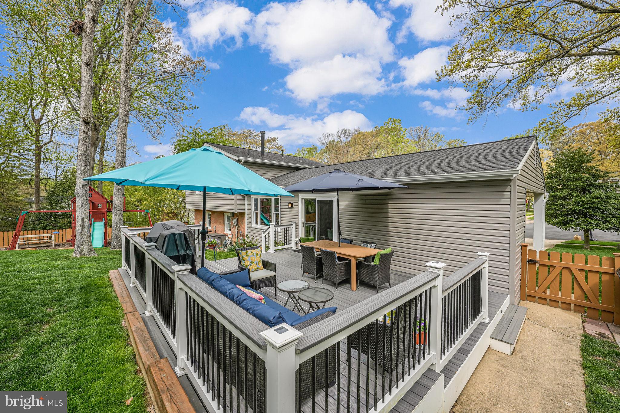 8315 Greeley Boulevard Springfield, VA 22152 - Photo 33 of 44 a balcony with furniture and an umbrella