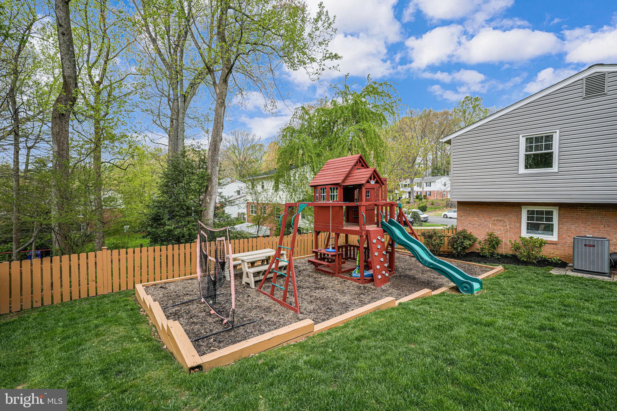 8315 Greeley Boulevard Springfield, VA 22152 - Photo 36 of 44 a view of a chair and table in backyard of the house