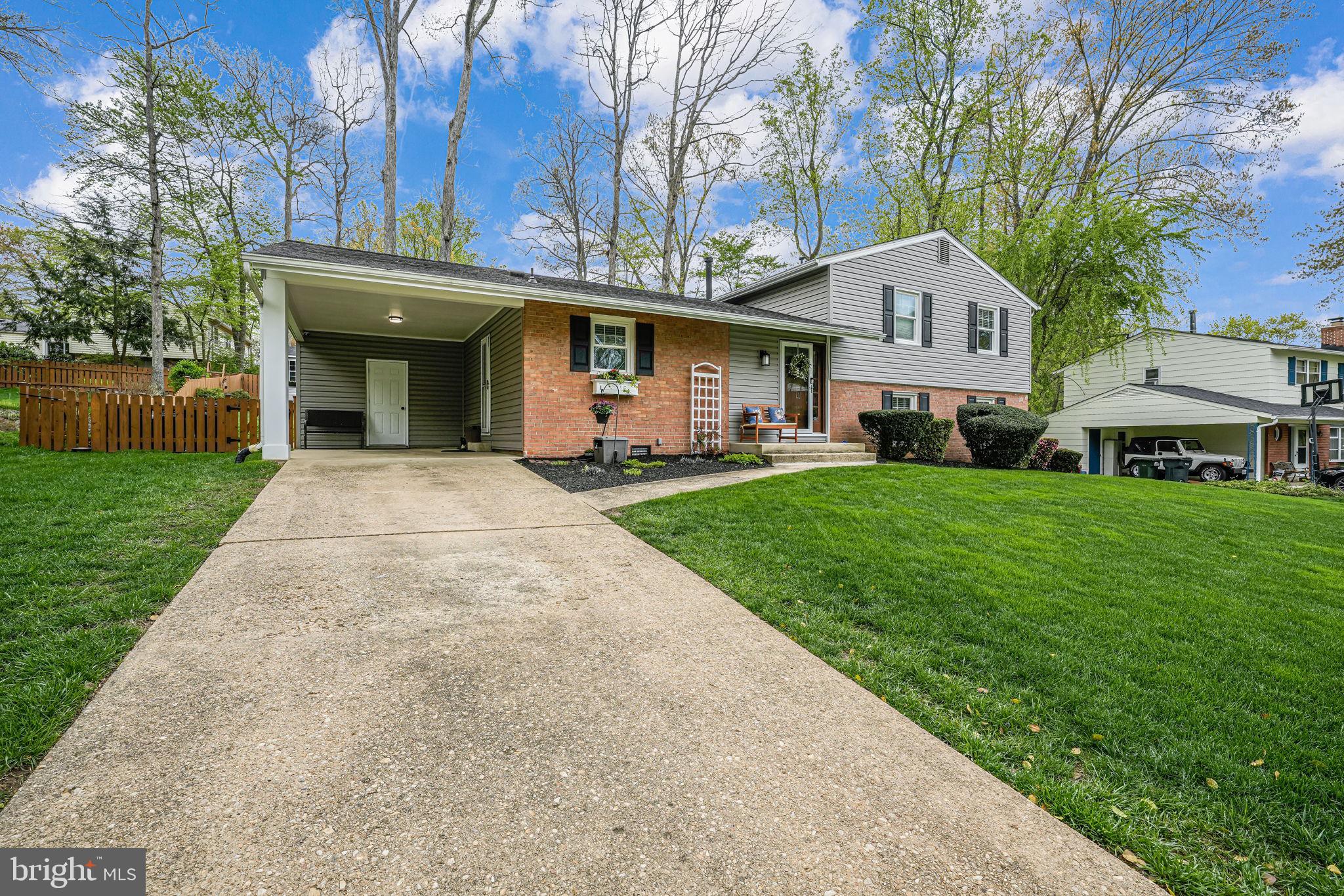 8315 Greeley Boulevard Springfield, VA 22152 - Photo 39 of 44 a front view of a house with a garden and trees