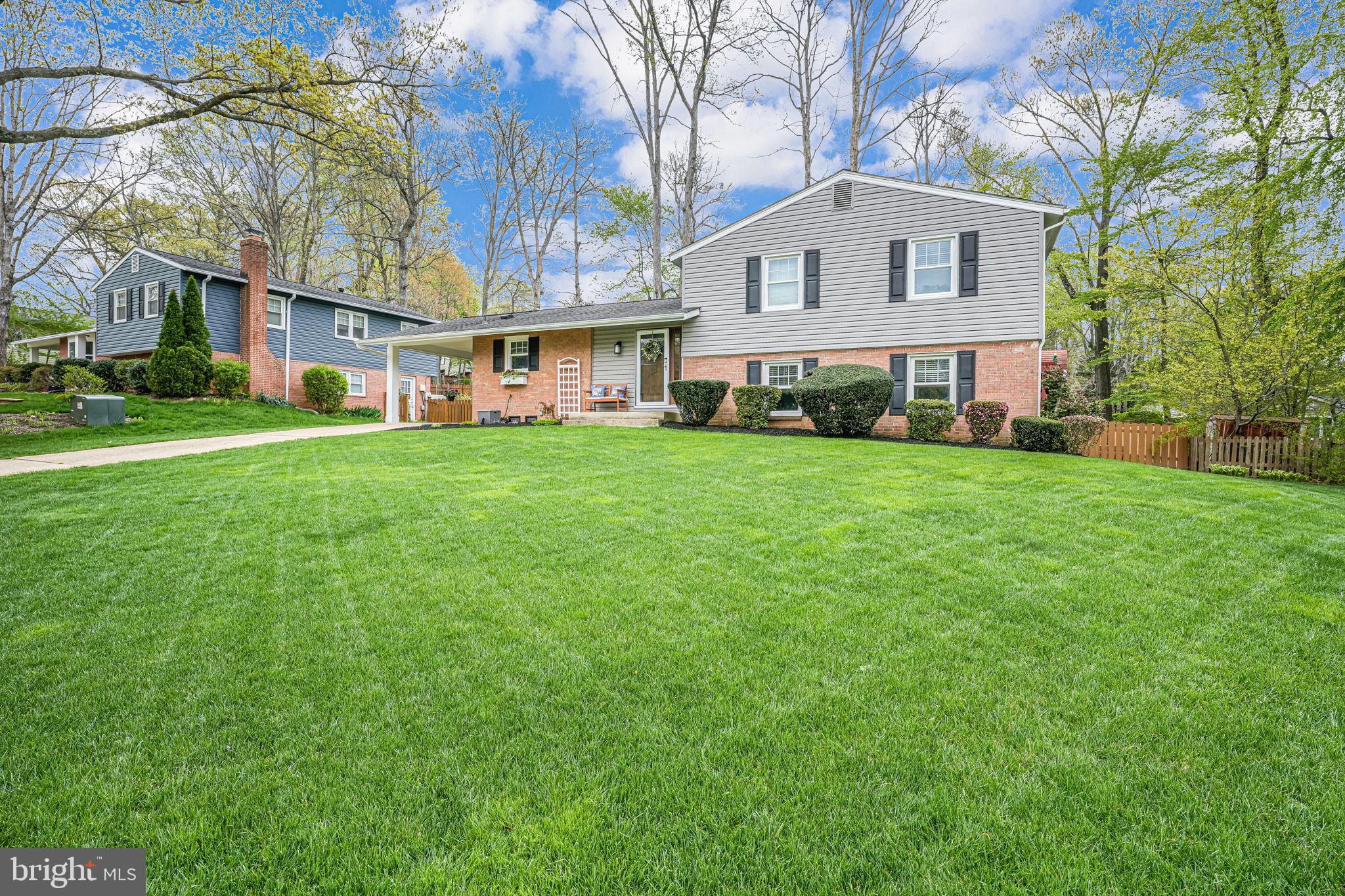 8315 Greeley Boulevard Springfield, VA 22152 - Photo 40 of 44 a front view of a house with a garden
