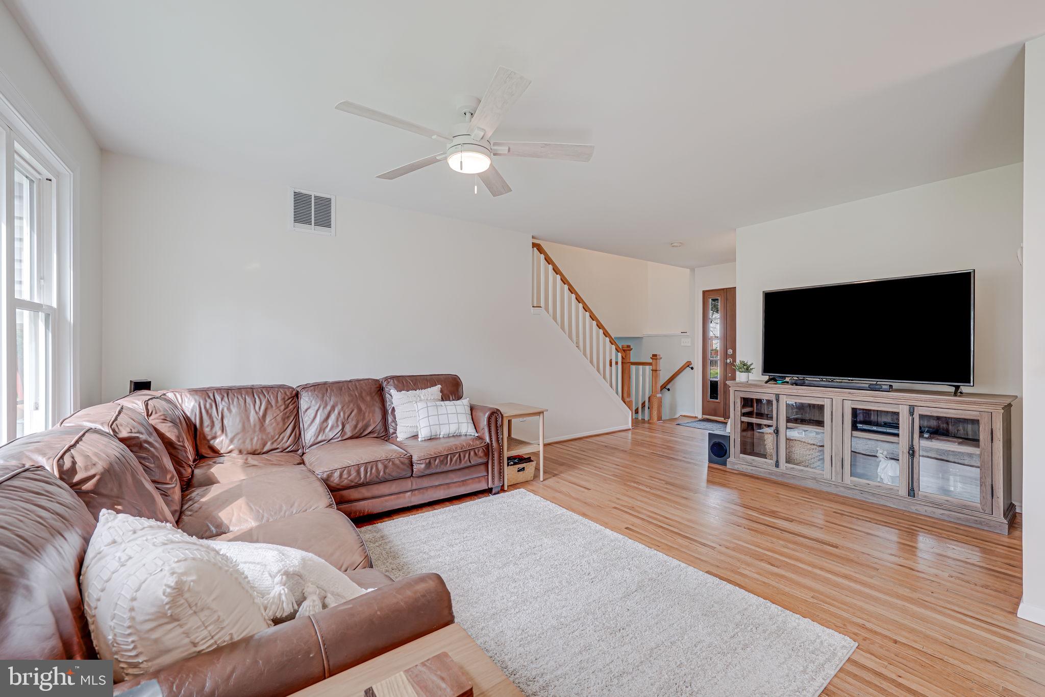 8315 Greeley Boulevard Springfield, VA 22152 - Photo 8 of 44 a living room with furniture and a flat screen tv