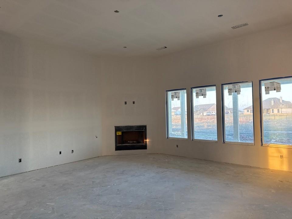 2212 Continent Court Krum, TX 76249 - Photo 8 of 15 a view of an empty room with a fireplace and a window