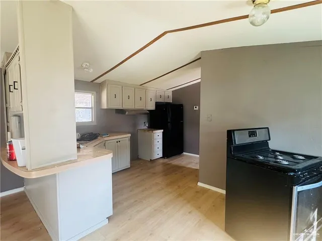 a kitchen with stainless steel appliances granite countertop a refrigerator and a stove