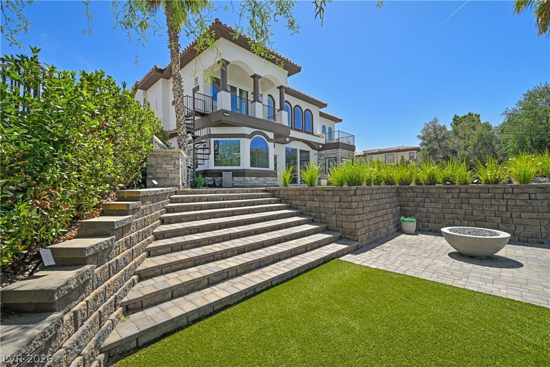 6 Rue Du Ville Henderson, NV 89011 - Photo 79 of 99 This grand exterior features a multi-level design with elegant architectural details and a private outdoor space.