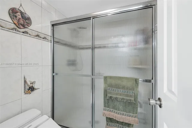 a bathroom with a glass shower door