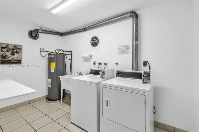 a view of washer and dryer with kitchen in the background