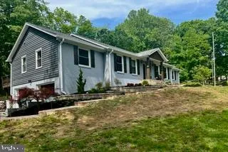 a view of a house with a yard covered with snow in the backyard