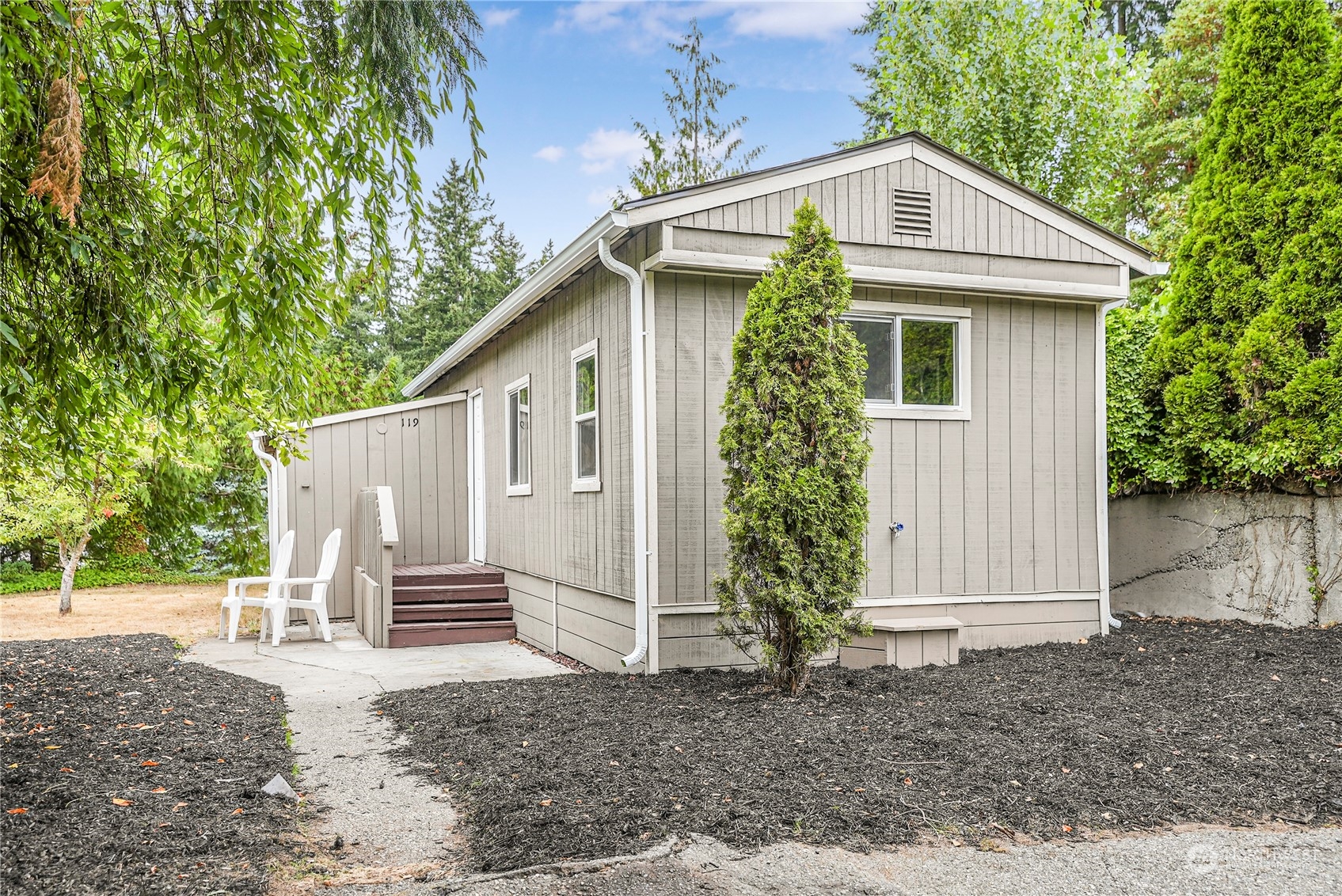 a view of a house with a yard and tree