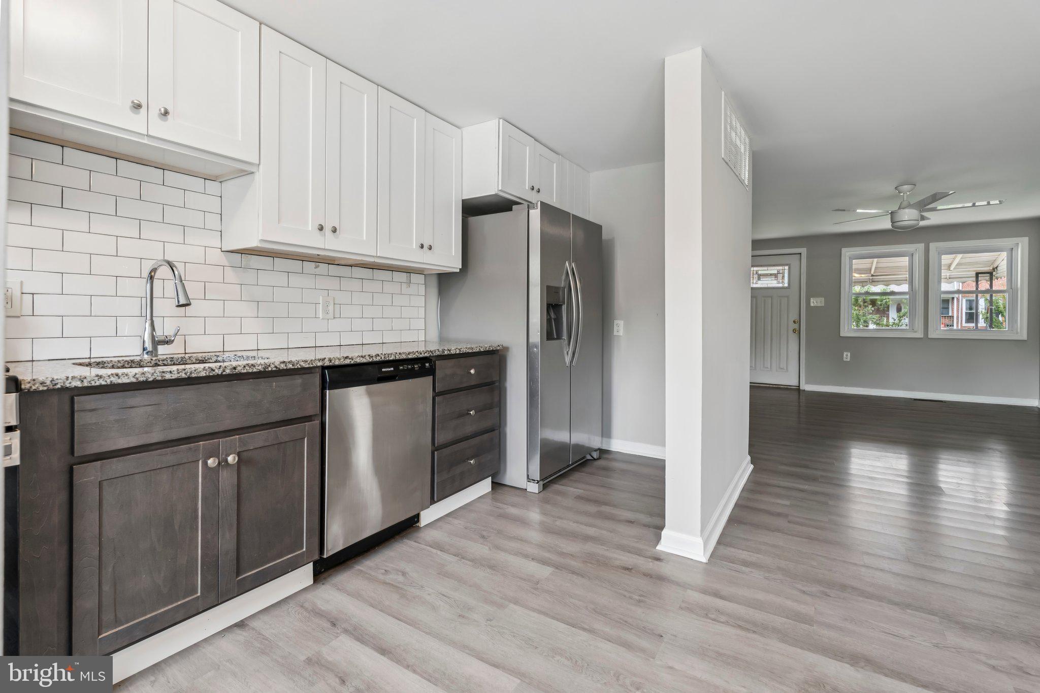 7838 St Boniface Lane Dundalk, MD 21222 - Photo 11 of 37 a kitchen with granite countertop a refrigerator and a sink
