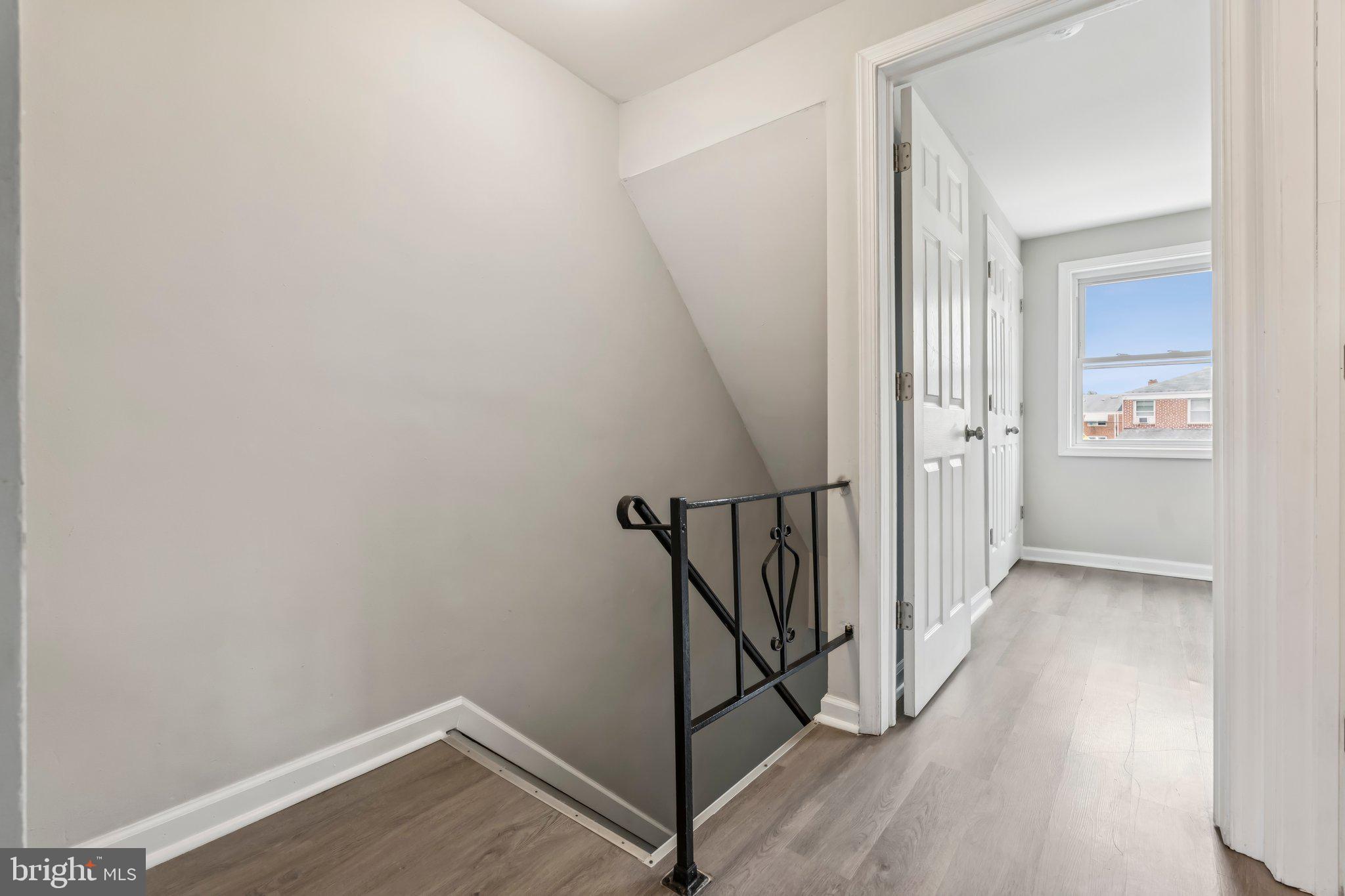 7838 St Boniface Lane Dundalk, MD 21222 - Photo 20 of 37 a view of a hallway with wooden floor and staircase