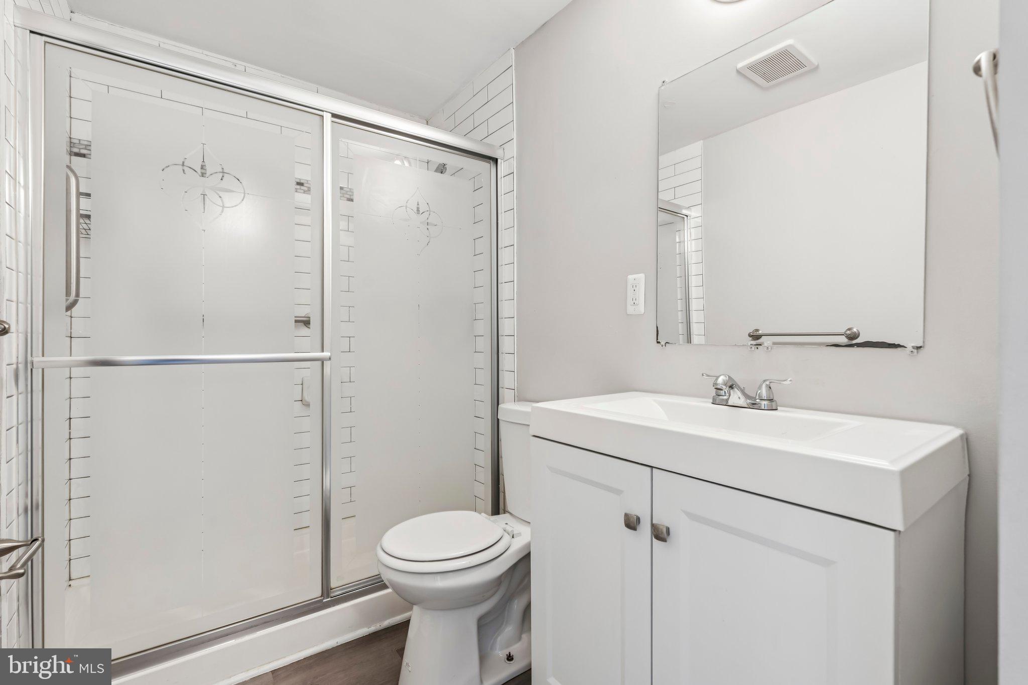7838 St Boniface Lane Dundalk, MD 21222 - Photo 22 of 37 a bathroom with a sink a toilet and shower