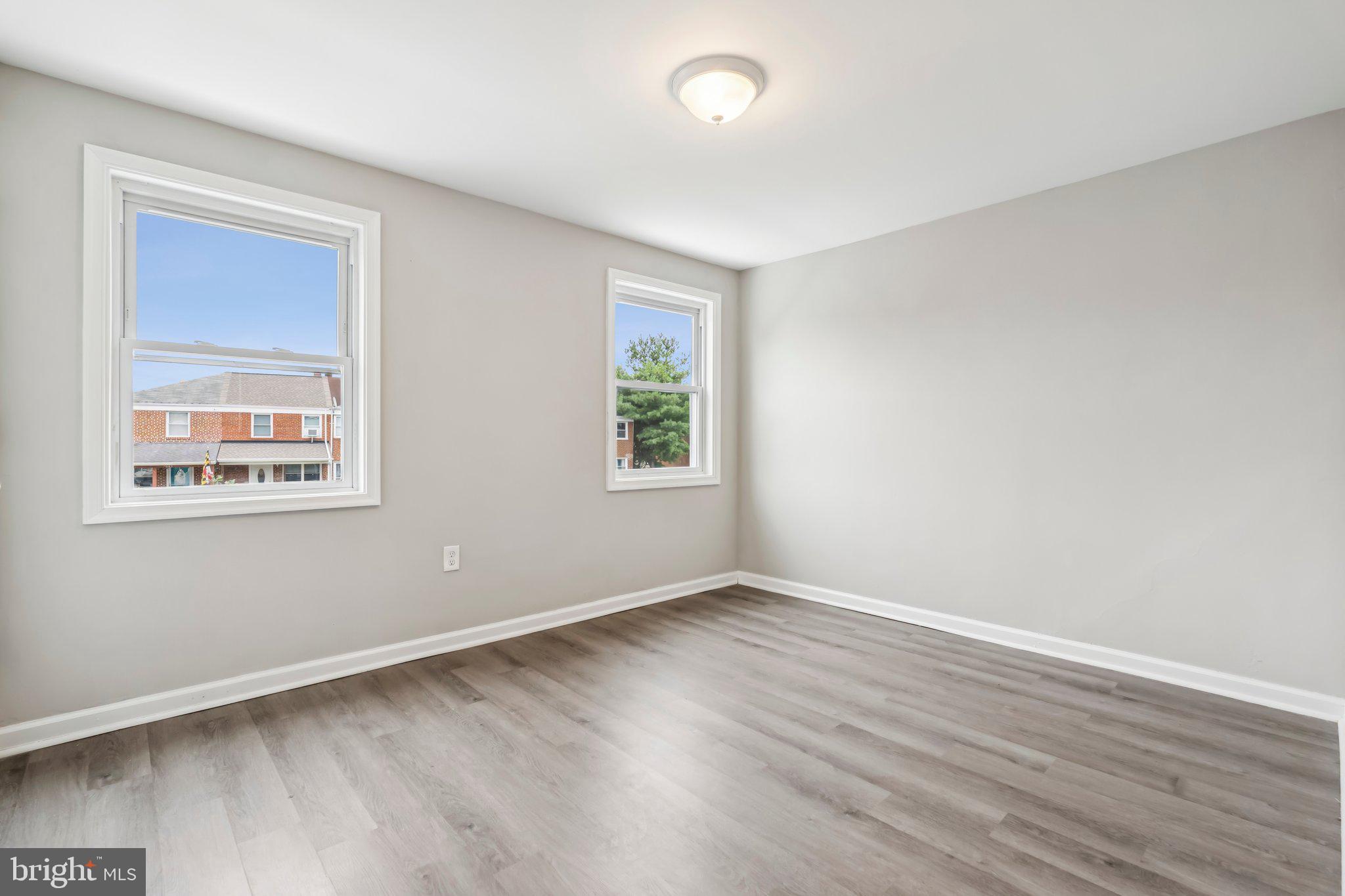7838 St Boniface Lane Dundalk, MD 21222 - Photo 23 of 37 a view of an empty room with wooden floor and a window