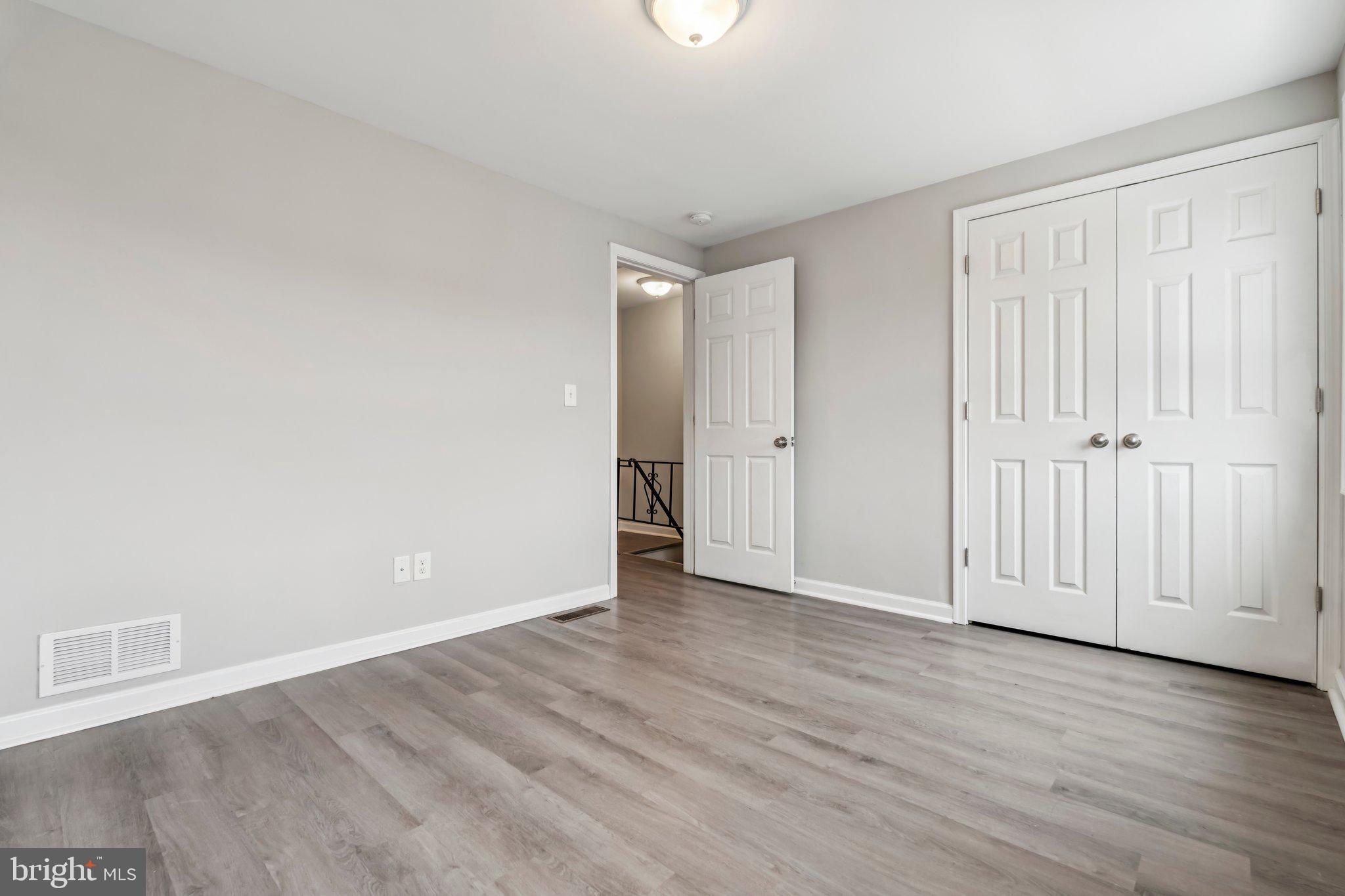 7838 St Boniface Lane Dundalk, MD 21222 - Photo 25 of 37 a view of an empty room with wooden floor
