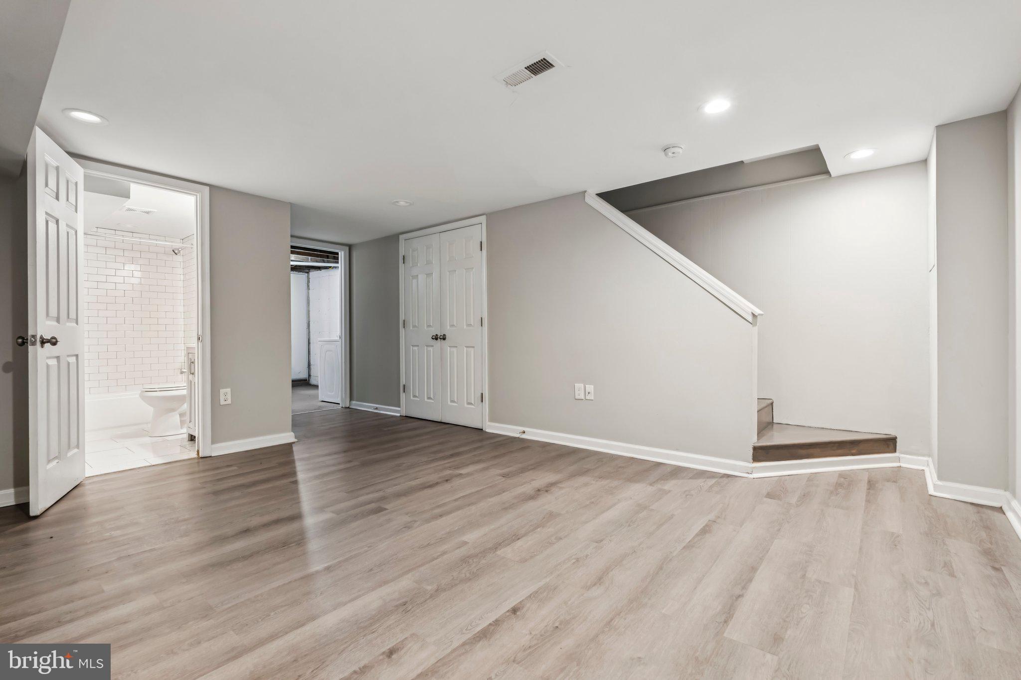 7838 St Boniface Lane Dundalk, MD 21222 - Photo 28 of 37 an empty room with wooden floor and windows