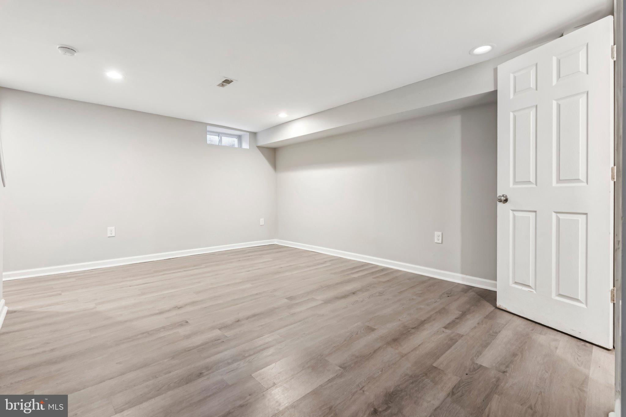 7838 St Boniface Lane Dundalk, MD 21222 - Photo 29 of 37 a view of an empty room with wooden floor