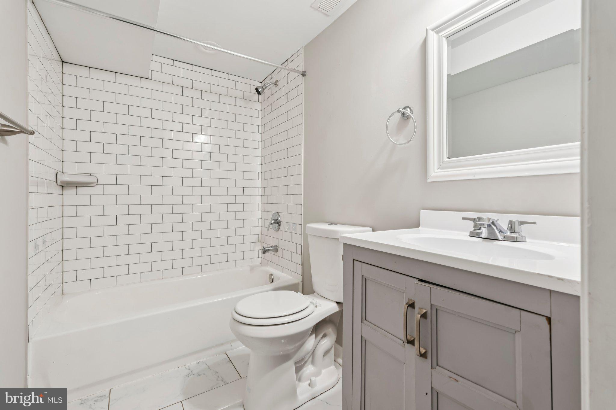 7838 St Boniface Lane Dundalk, MD 21222 - Photo 30 of 37 a bathroom with a sink a toilet and shower