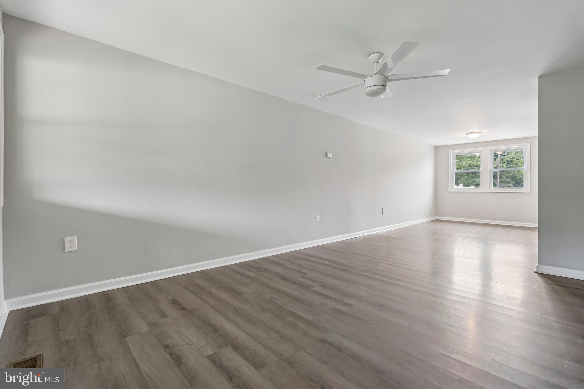 7838 St Boniface Lane Dundalk, MD 21222 - Photo 3 of 37 wooden floor in an empty room with a window