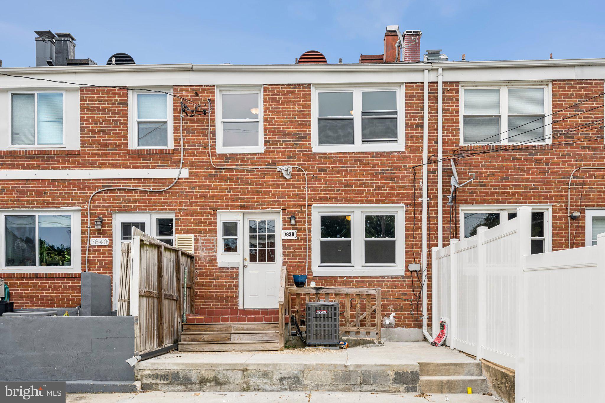 7838 St Boniface Lane Dundalk, MD 21222 - Photo 33 of 37 a front view of a building with a brick wall