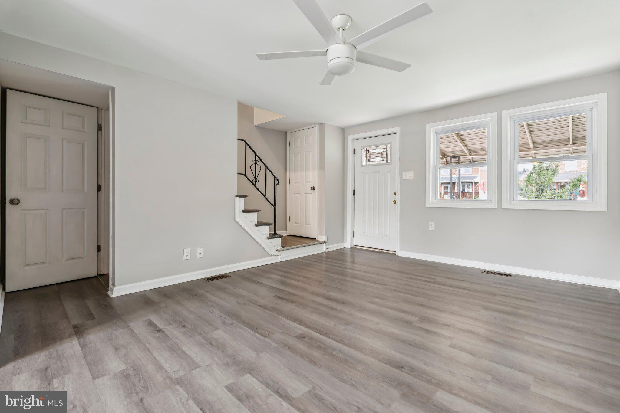 7838 St Boniface Lane Dundalk, MD 21222 - Photo 5 of 37 a view of an empty room with wooden floor and a window